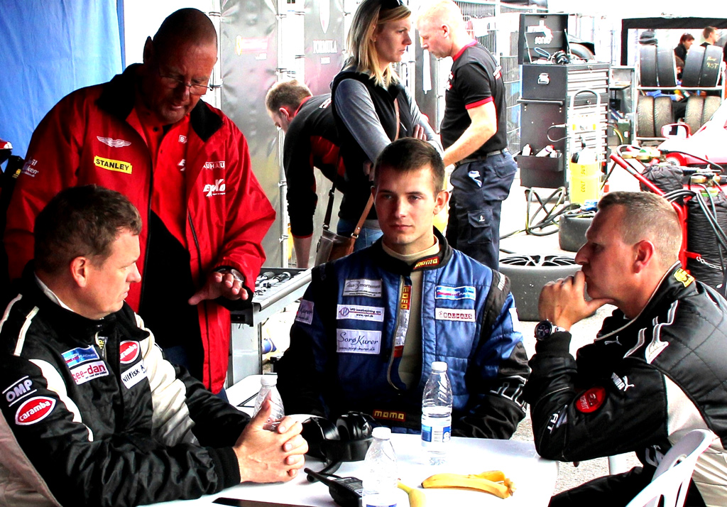 Teamets koordinator Erik instrurerer Mikkel C. (i midten) og hans to medkørere i dagens strategier.
(Foto: RacingPromotion.dk)